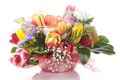 A vibrant bouquet of assorted flowers in a decorative vase