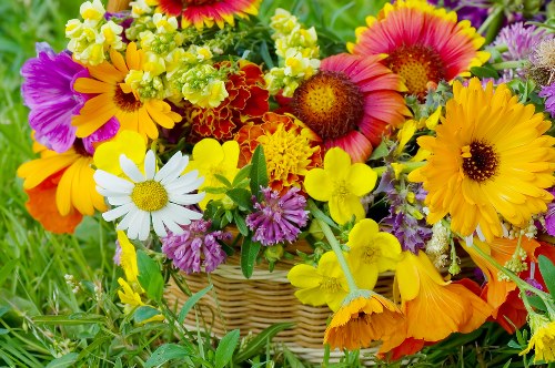 Delivery person presenting a fresh flower arrangement at doorstep